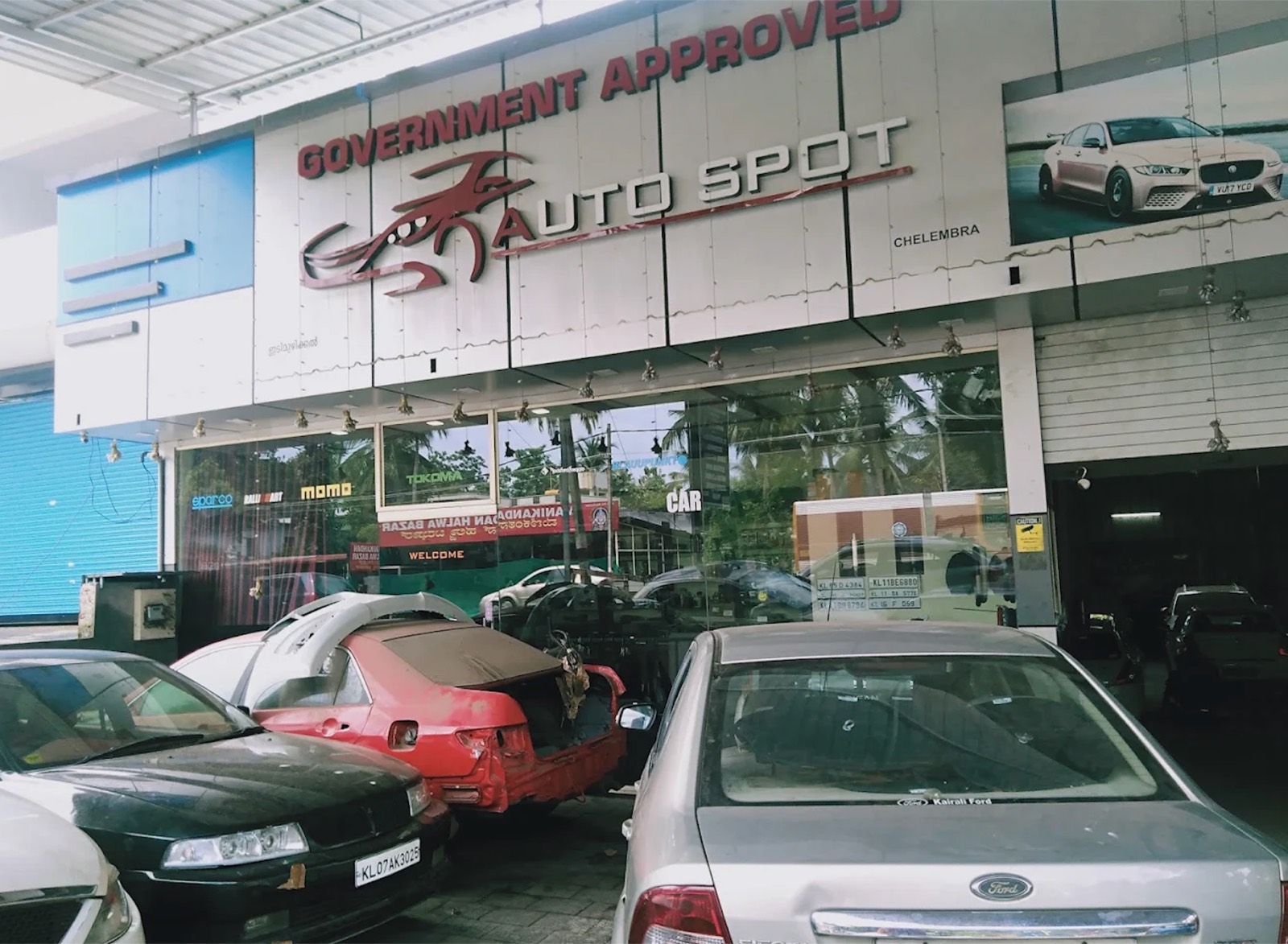 Auto Spot Malappuram signboard above the service bays with cars in for repair