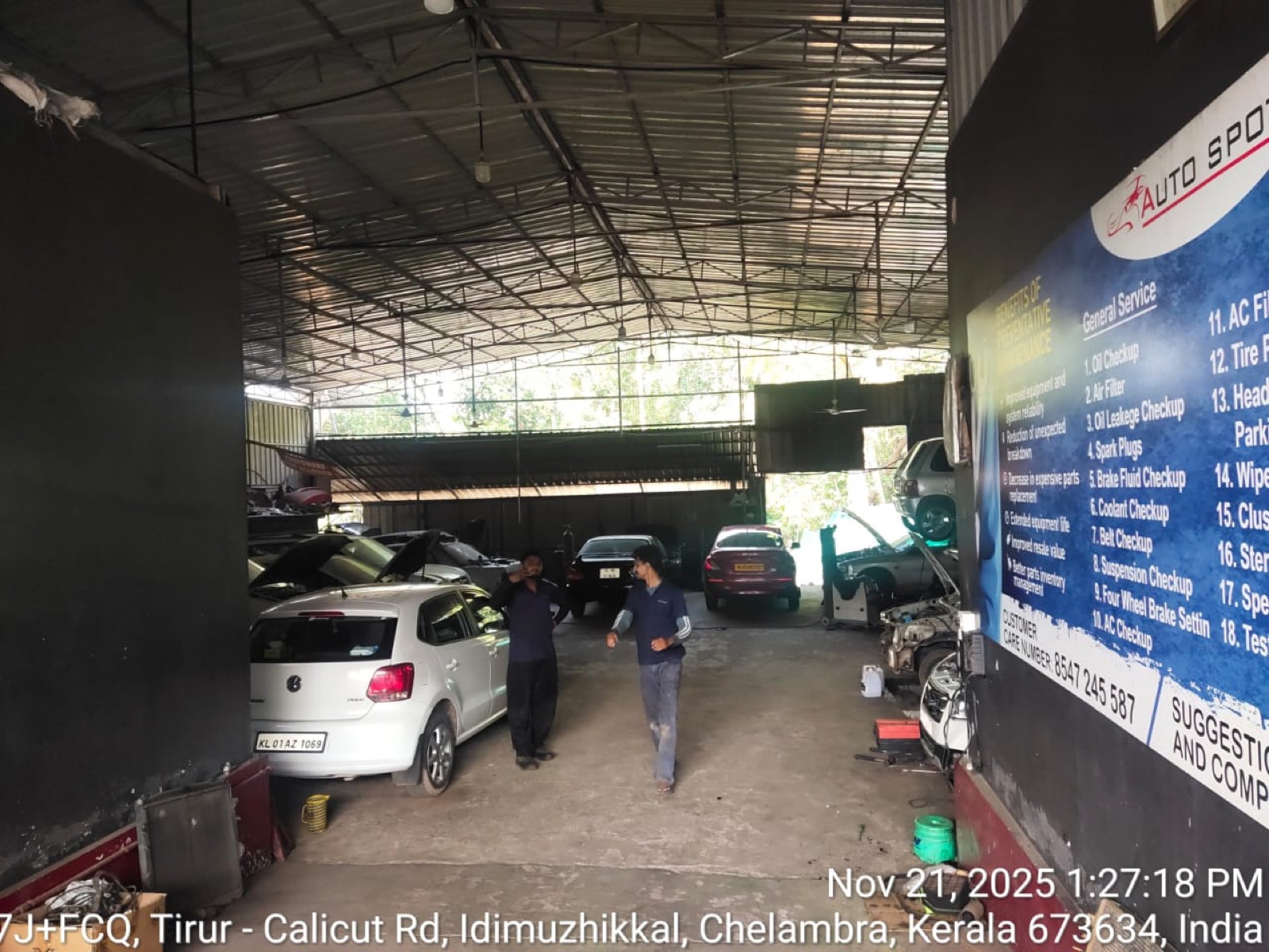 Technicians at work inside the covered service bay at the Auto Spot Malappuram workshop